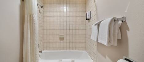 A bathroom with a bathtub, a shower, and a toilet.