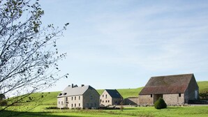 A stone farmhouse with a large barn, surrounded by green fields and a clear sky. - Holiday Home in Falaën with Garden BBQ (Stave)