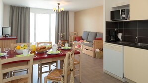 A modern kitchen with a microwave, coffee maker, and dishwasher.