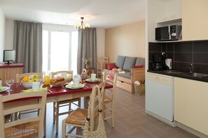 A modern kitchen with a microwave, coffee maker, and dishwasher.