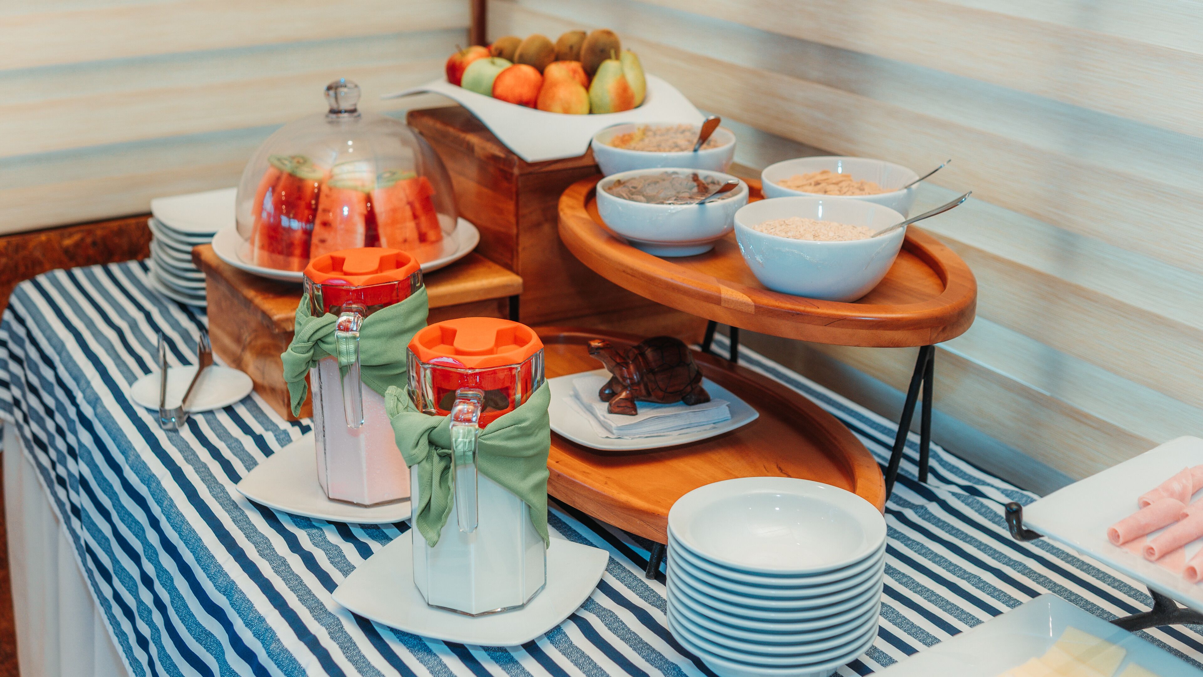 A breakfast buffet with various food items and utensils.