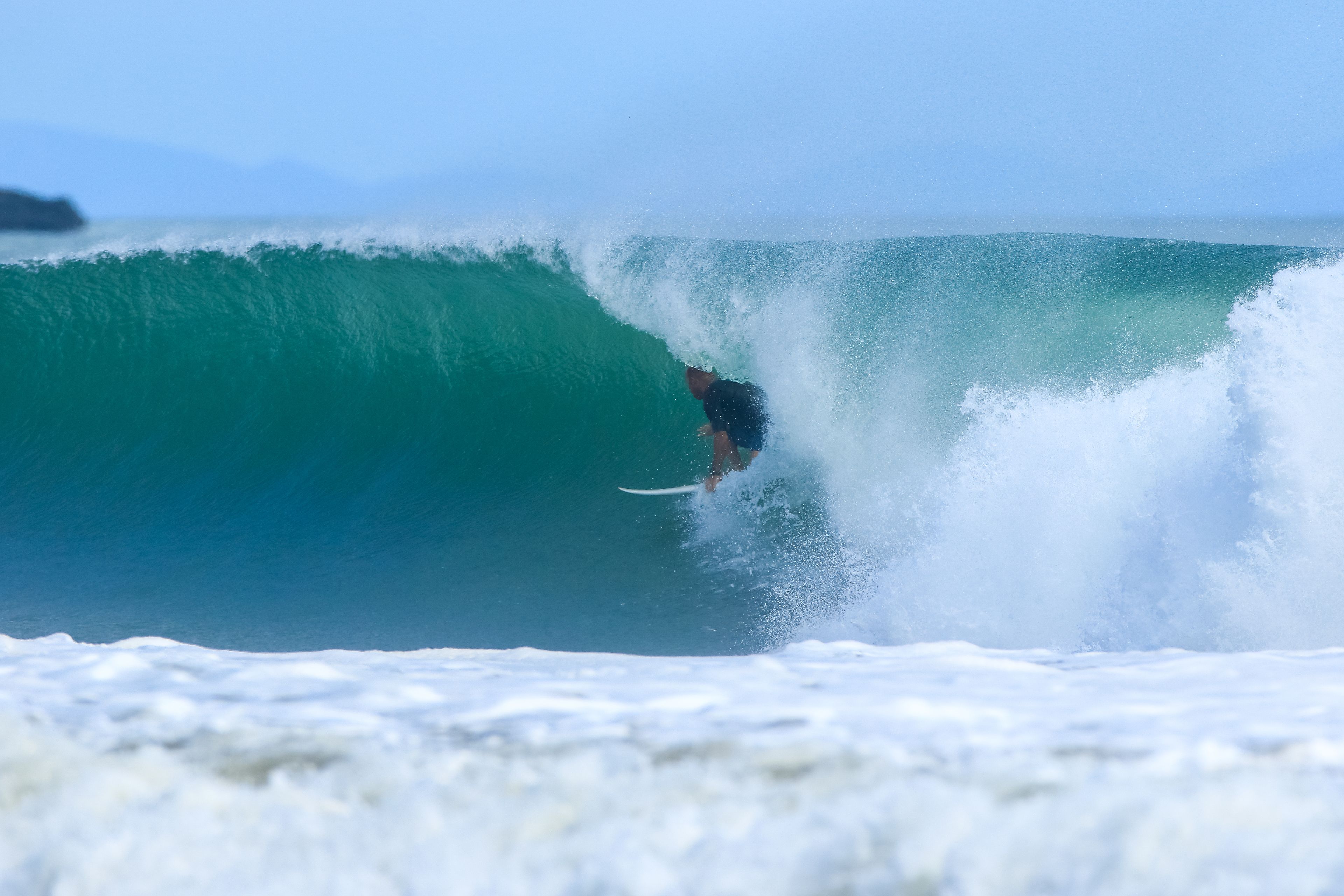 A surfer riding a large wave.