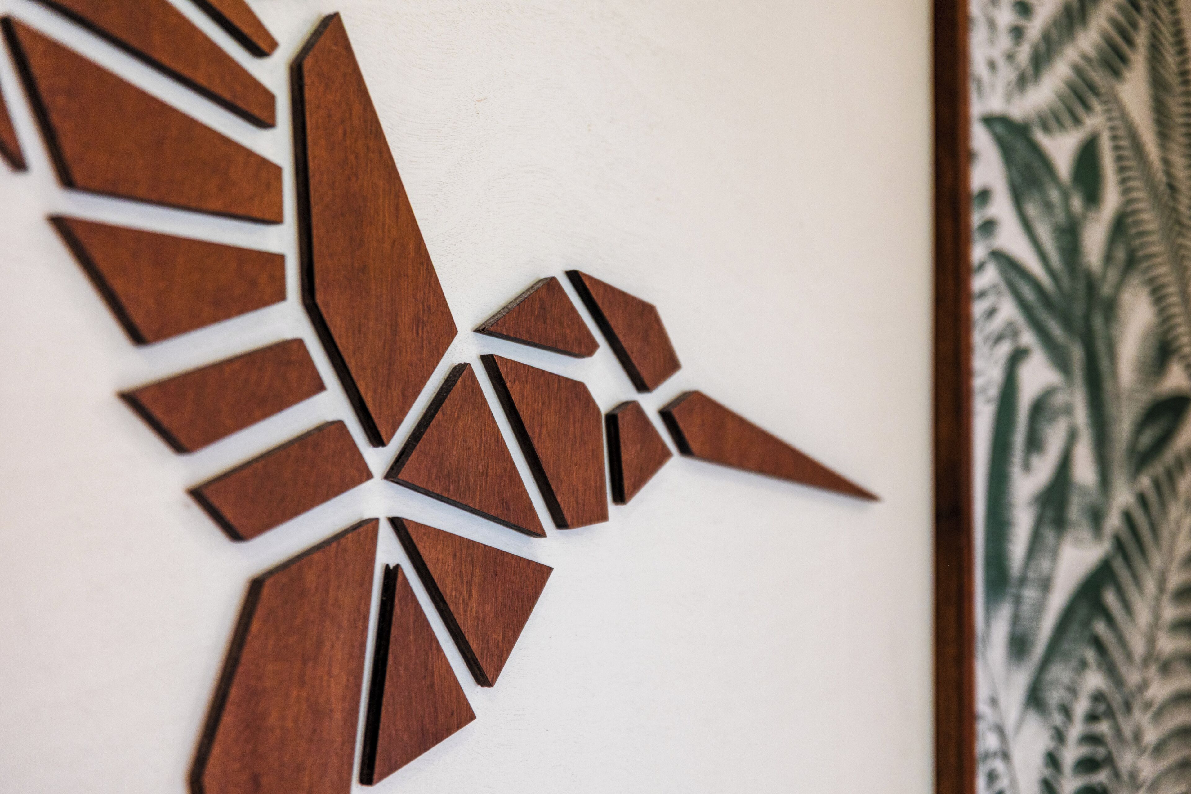 A wooden wall art piece with geometric shapes.