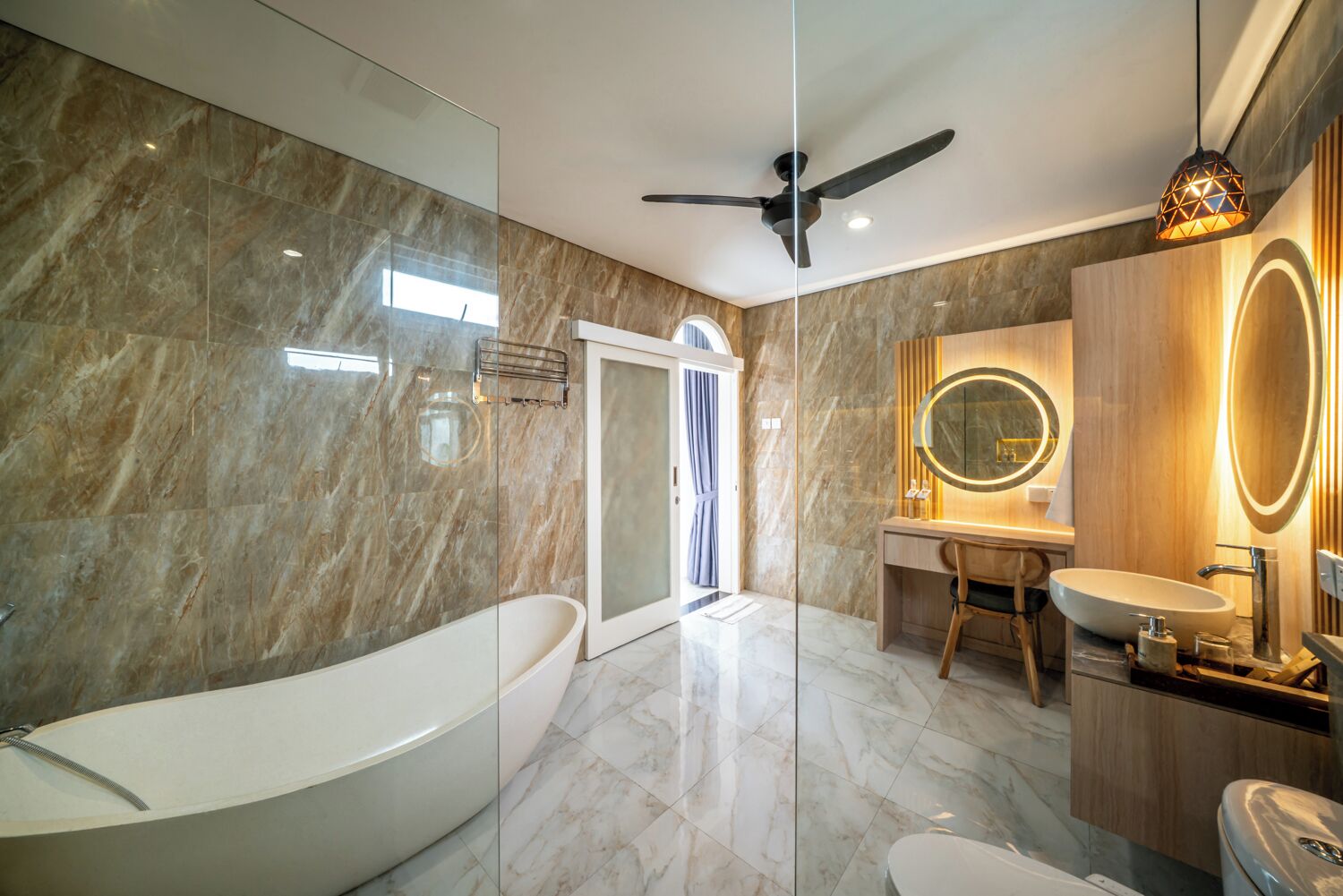 A modern bathroom with a freestanding bathtub, a vanity with a mirror, and a shower area.