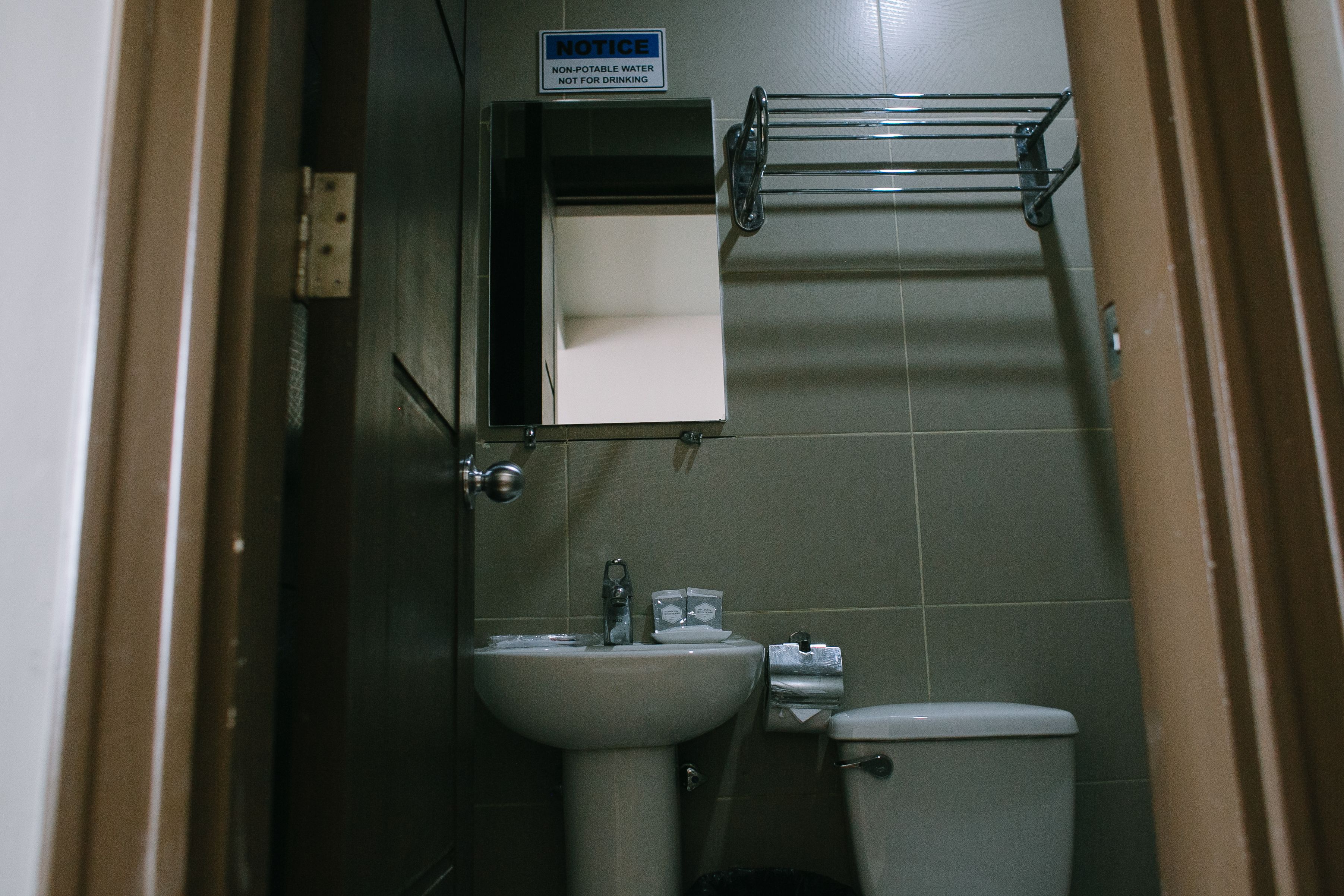 deluxe room, 1 queen bed | bathroom | shower, free toiletries, hair dryer, slippers