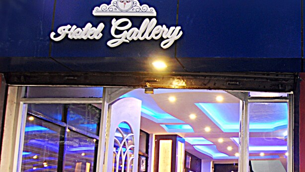 A hotel entrance with a sign reading "Fistel Gallery." Inside, there are red seating areas and a reception desk. - Hotel Gallery Nepal (Kathmandu)
