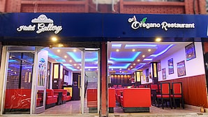 A restaurant with red seating and a modern interior design. - Hotel Gallery Nepal (Kathmandu)
