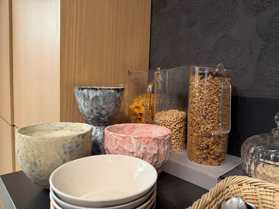 A table with various bowls and containers, some with food items.