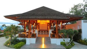 A covered outdoor seating area with a wooden structure, steps leading up to it, and a view of the surrounding landscape. - Mount Inle Hotel & Resorts (Nyaungshwe)