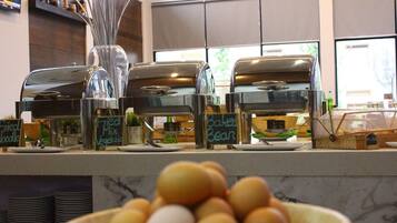 A coffee station with a display of eggs and signs indicating available coffee options.