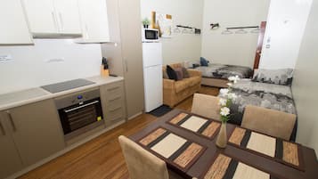 Basic Apartment, 1 Bedroom (Apartment 8) | Living area | Flat-screen TV