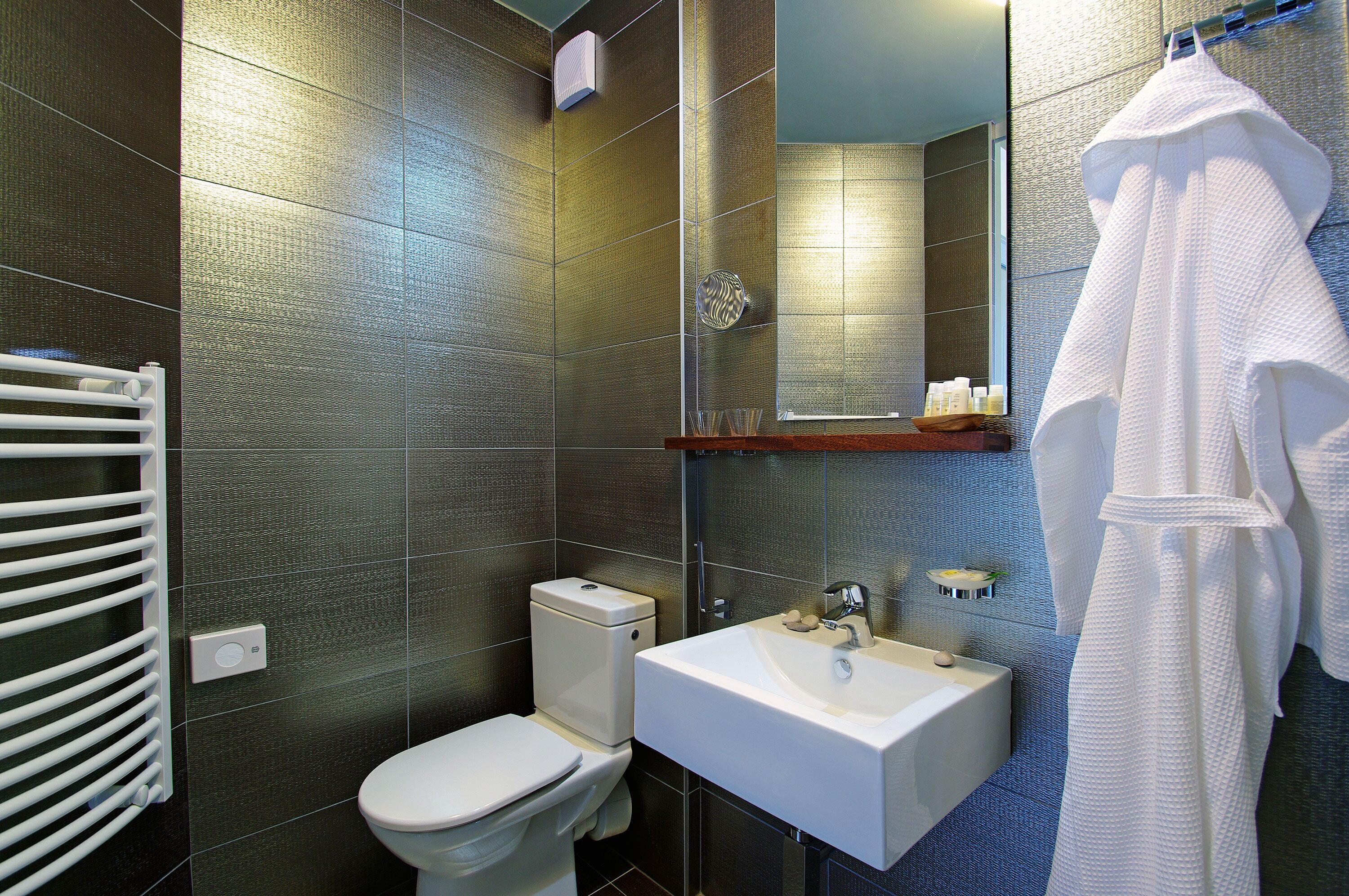 deluxe family room with balcony and pool view | bathroom | eco-friendly toiletries, hair dryer, bathrobes, slippers