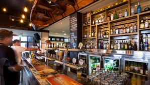 A bar area with a beer tap, shelves with bottles, and a chalkboard with writing. - Nightcap at Caringbah Hotel (Caringbah)