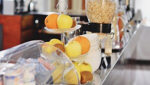 A buffet setup with various food items and beverages. - Hôtel de France (Saint-Savin)