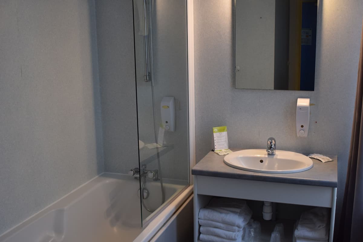 family quadruple room, multiple beds | bathroom | free toiletries, hair dryer, towels