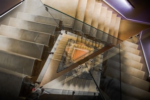 A modern staircase with glass railings and a geometric design. - Hydrama Grand Hotel (Drama)