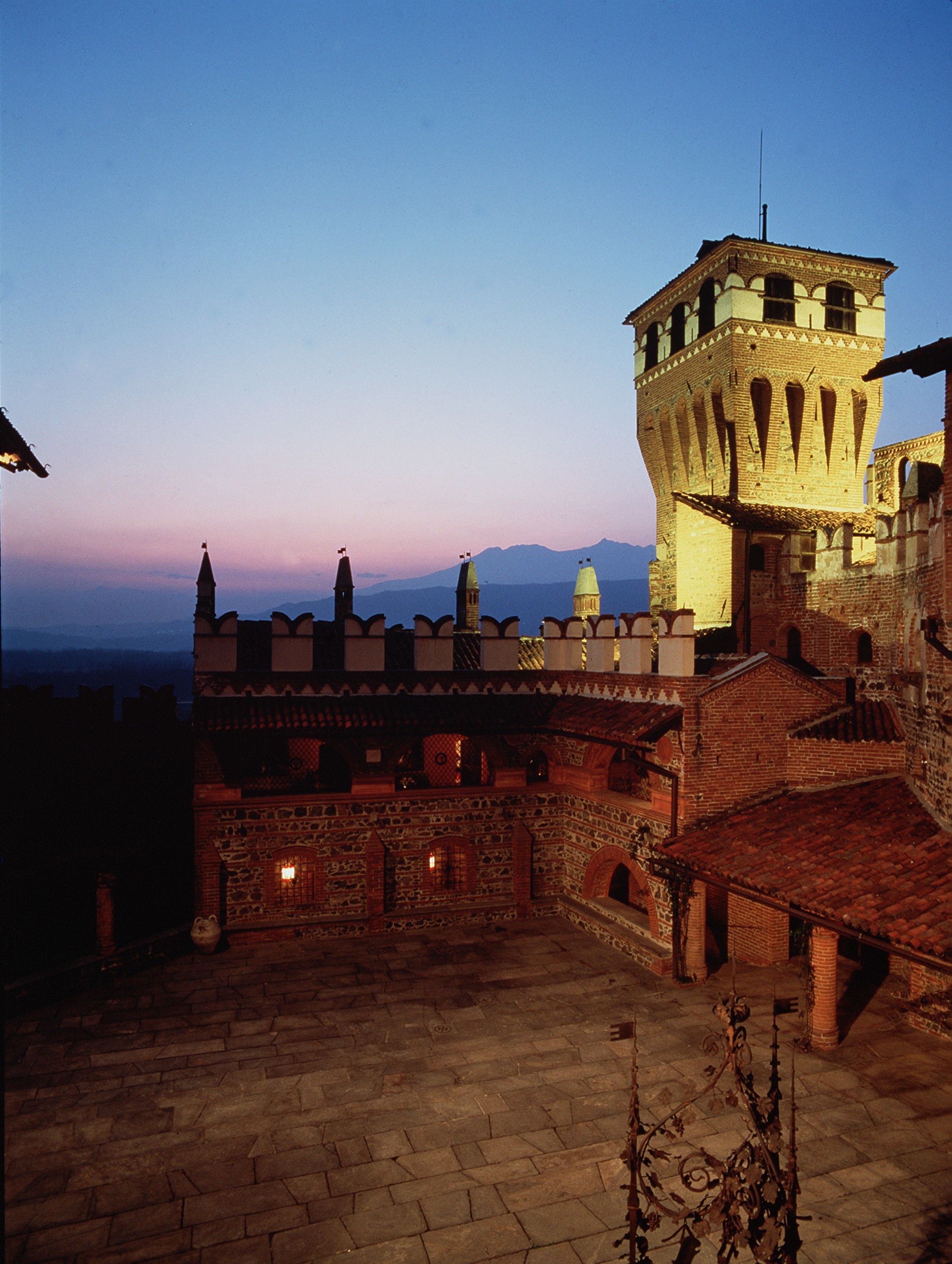 A historic building with a tower and a courtyard.