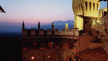 A historic building with a tower and a courtyard.