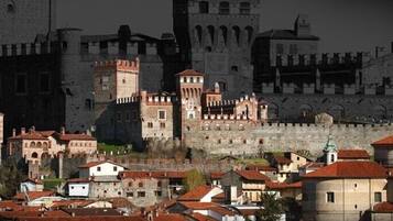 A historic town with medieval architecture, including a prominent castle and fortified walls.