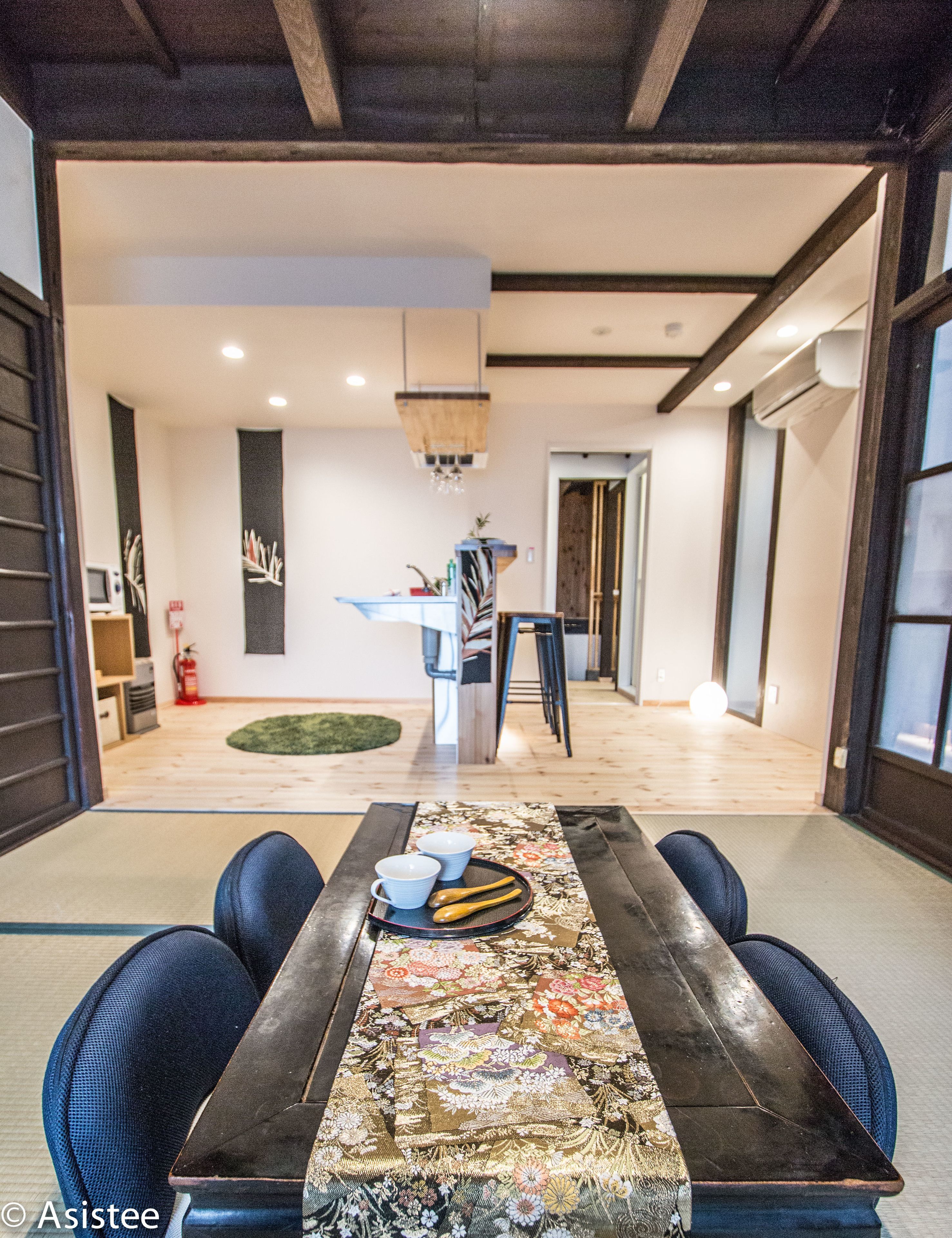 A modern dining area with a wooden table, blue chairs, and a decorative table runner.