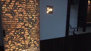 A door with a decorative metal panel and a sign with Japanese characters.