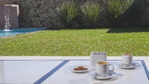 A table with two cups of coffee, a plate of cookies, and a coffee pot. - Amalinas Hotel (Villa San Lorenzo)