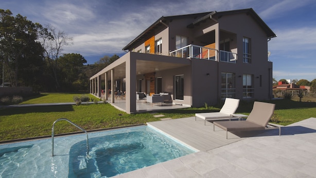 A modern two-story house with a swimming pool, outdoor seating, and a well-maintained lawn. - Amalinas Hotel (Villa San Lorenzo)
