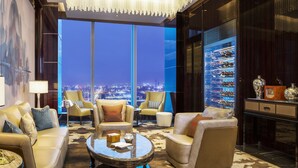 A luxurious hotel lobby with a high-rise city view, plush seating, and a wine display. - The St. Regis Changsha (Changsha)