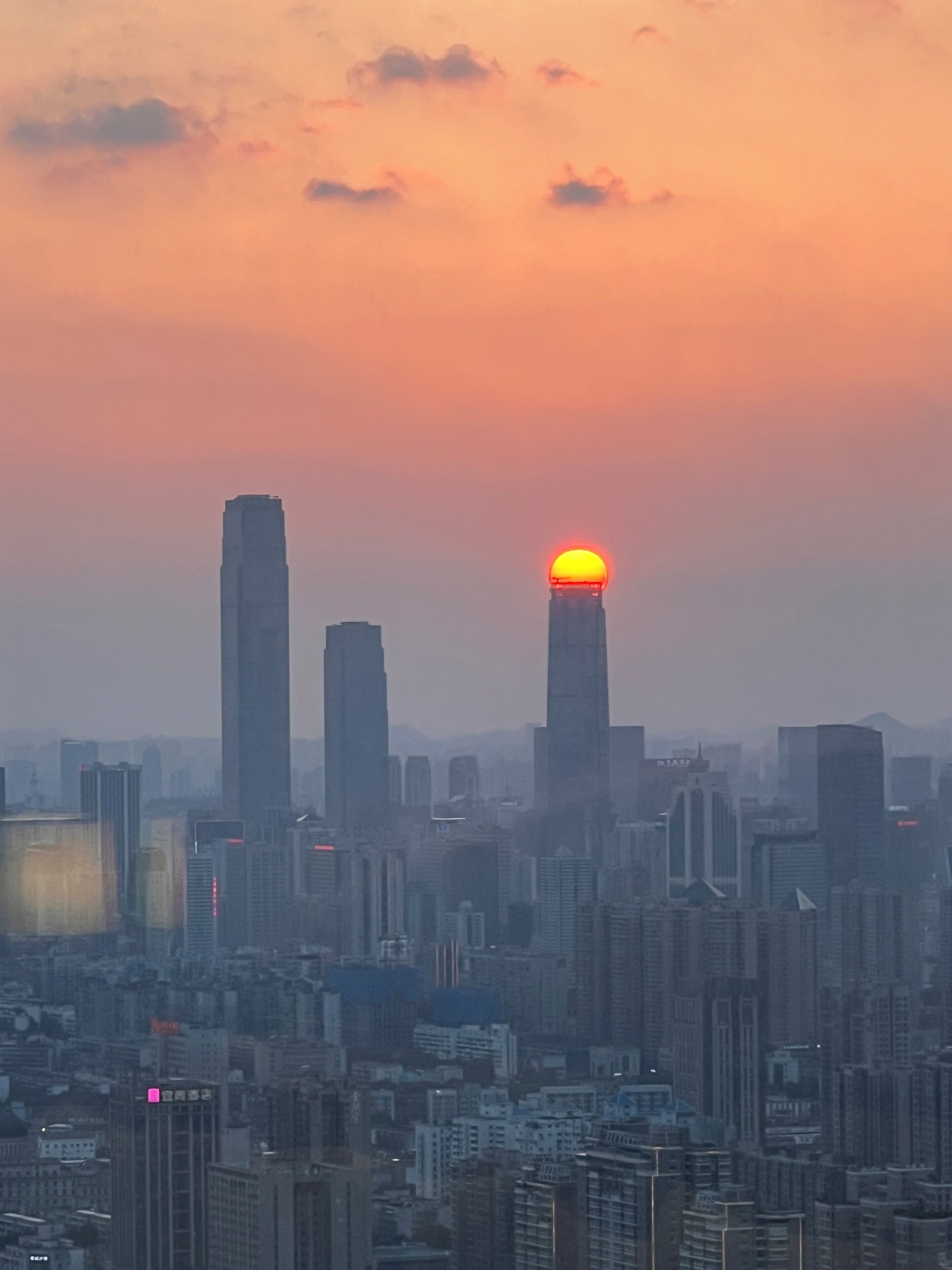 Paisagem urbana com arranha-céus e pôr do sol.