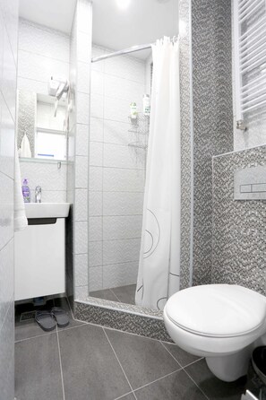 Economy Quadruple Room, 4 Persons | Bathroom | Shower, free toiletries, hair dryer, towels