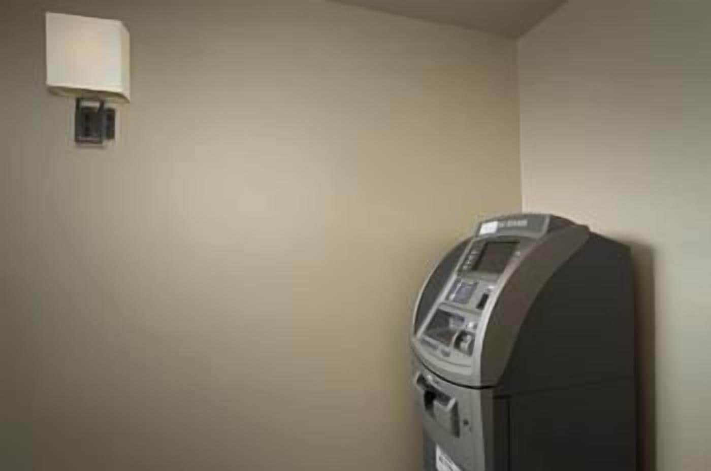 A room with a built-in microwave and a wall-mounted lamp.