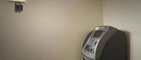 A room with a built-in microwave and a wall-mounted lamp.