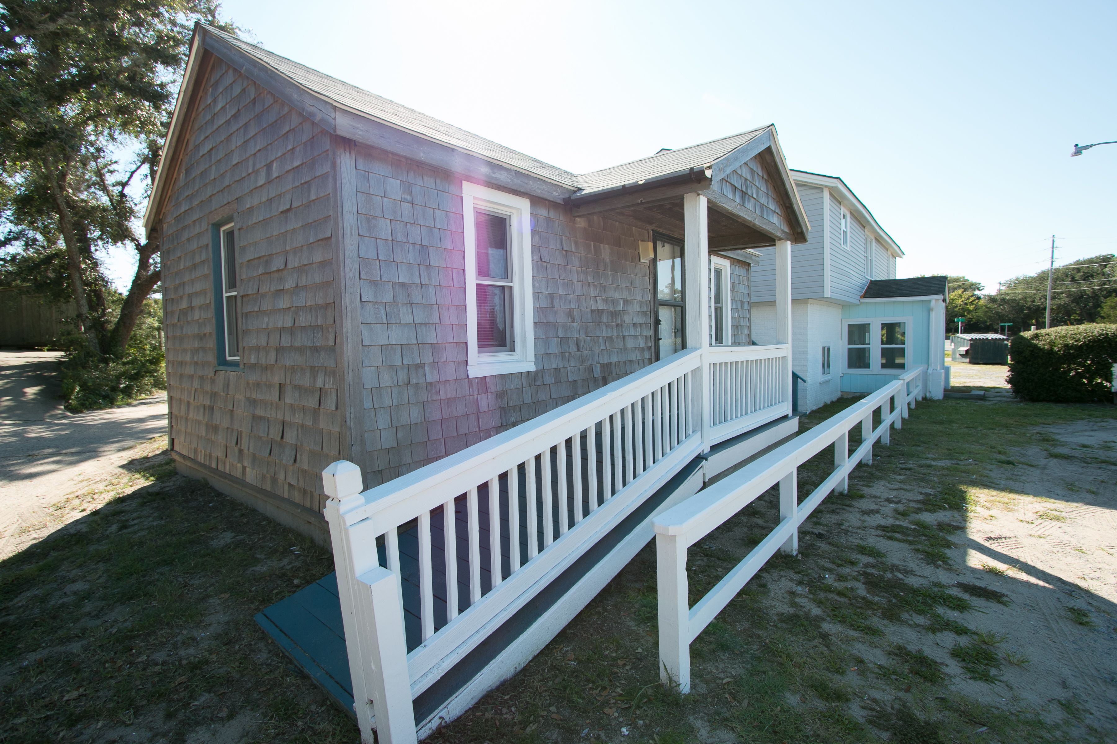A two-story house with a front porch and a small attached garage.