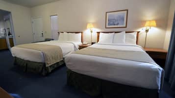 A hotel room with two beds, a painting on the wall, and two bedside lamps.