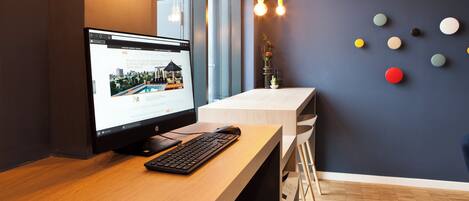 A modern office desk with a computer, keyboard, and mouse.