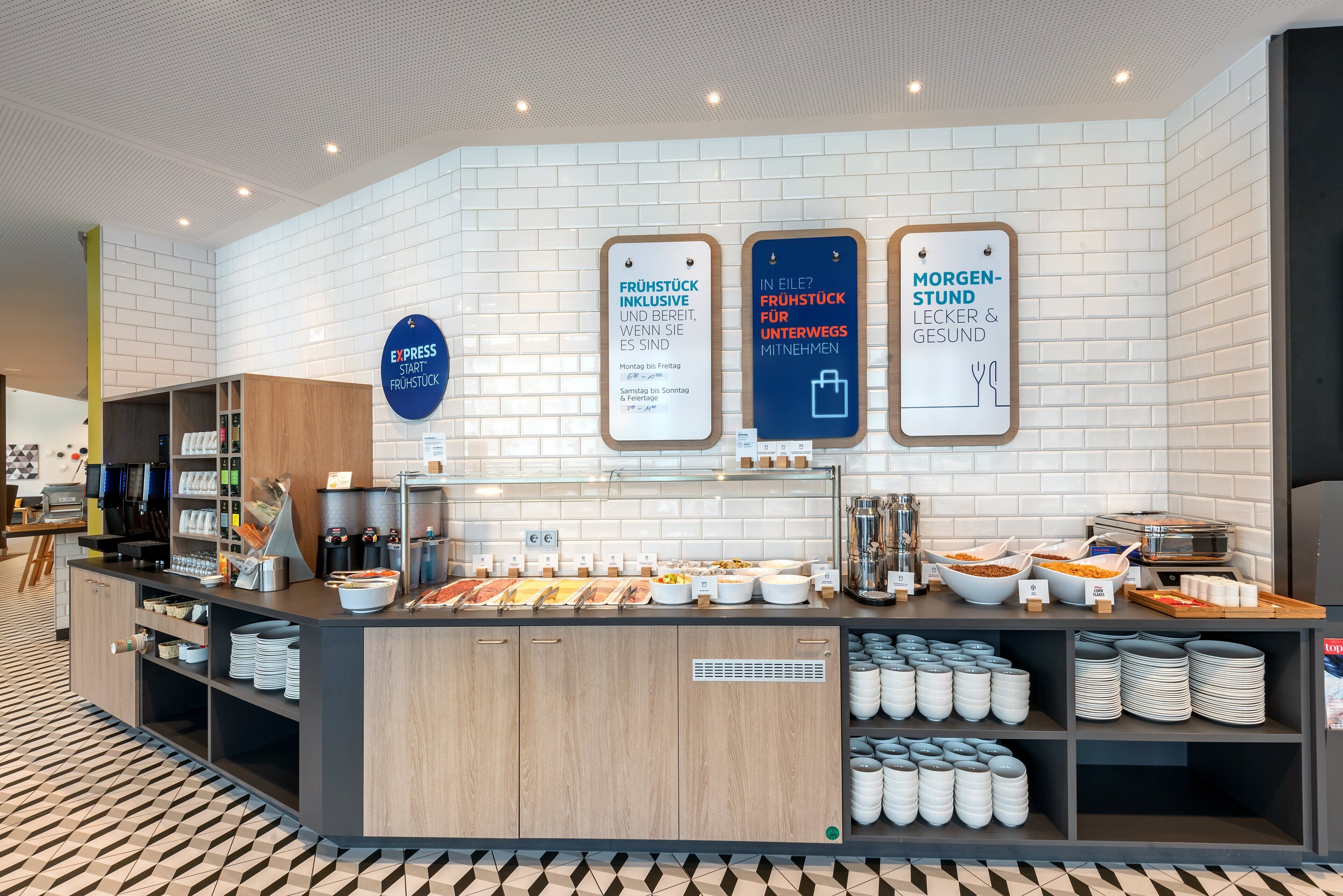 A breakfast buffet area with various food options and a coffee station.