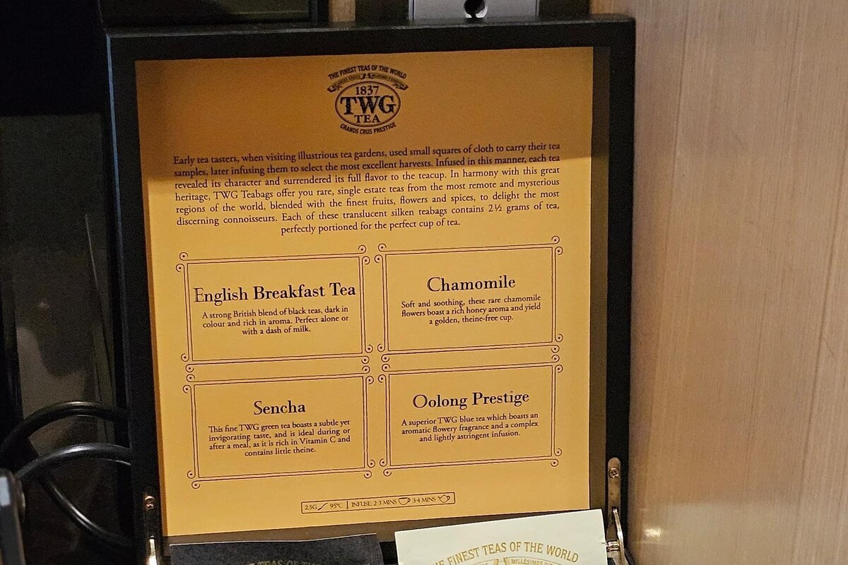 A black box containing three TWG tea bags labeled English Breakfast Tea, Chamomile, and Sencha.