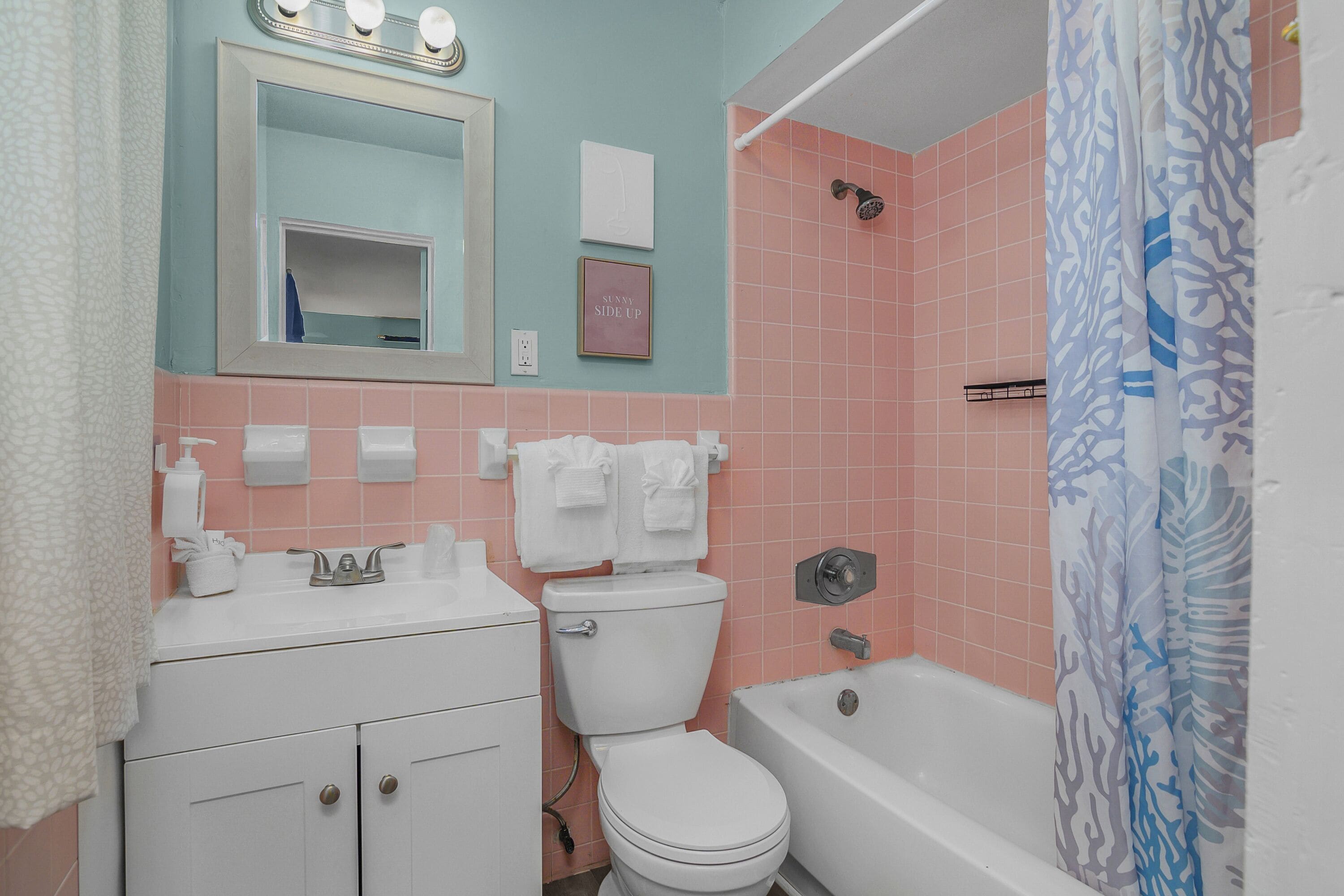 A bathroom with a toilet, sink, and bathtub.