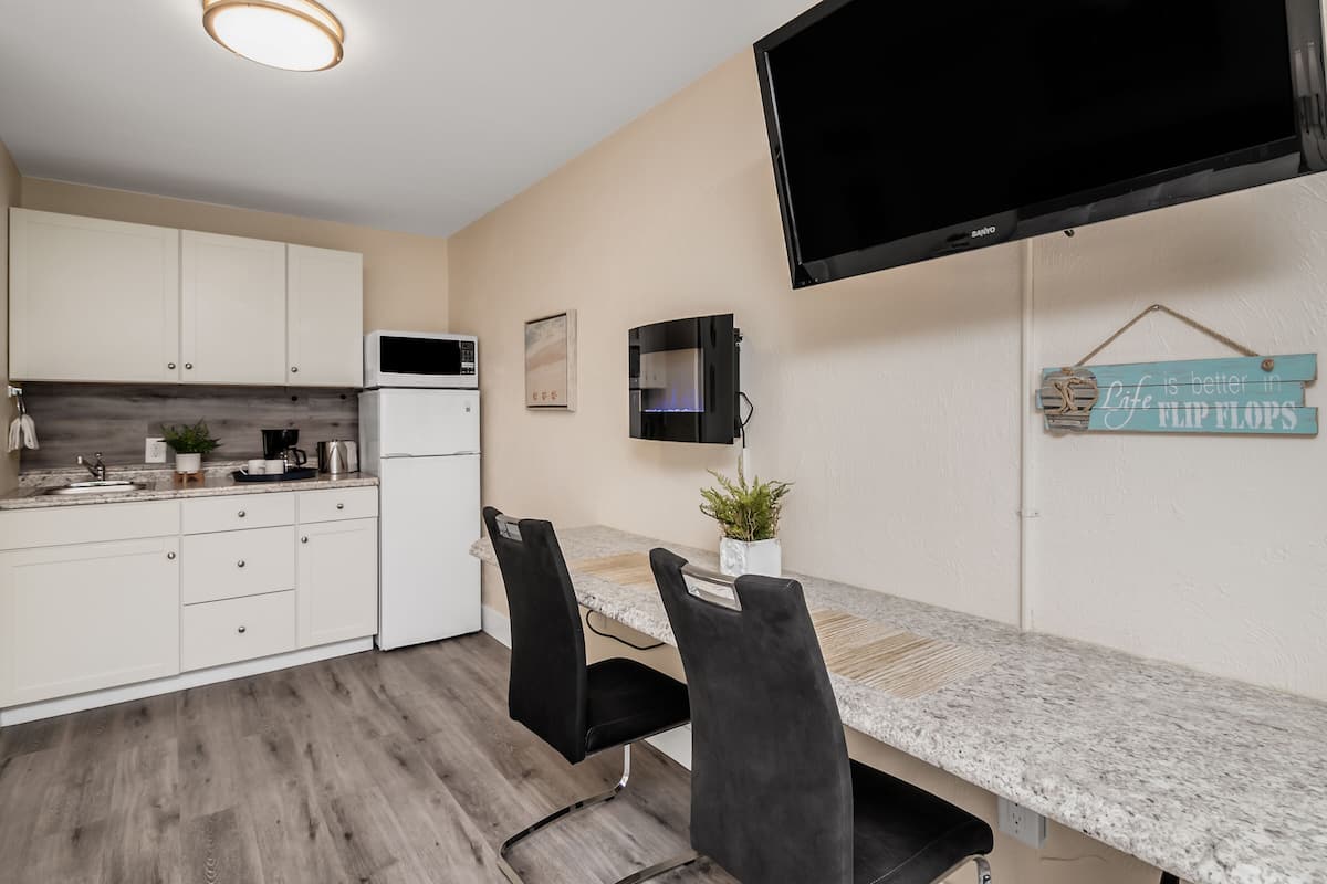 deluxe studio, 2 queen beds, kitchenette | 1 bedroom, blackout curtains, iron/ironing board, free wifi