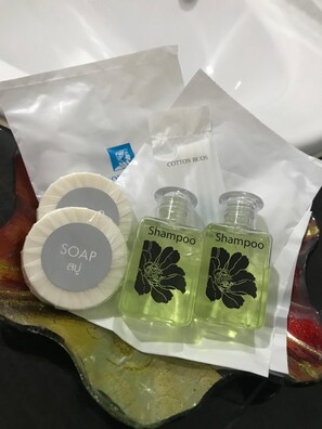 A package containing two shampoo bottles, a soap bar, and a cotton buds bag. - TTT Hotel (Hat Yai)