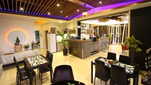 A modern kitchen with a central island, wooden ceiling, and ambient lighting. - Kingdom Love Bed and Breakfast (Ji'an)