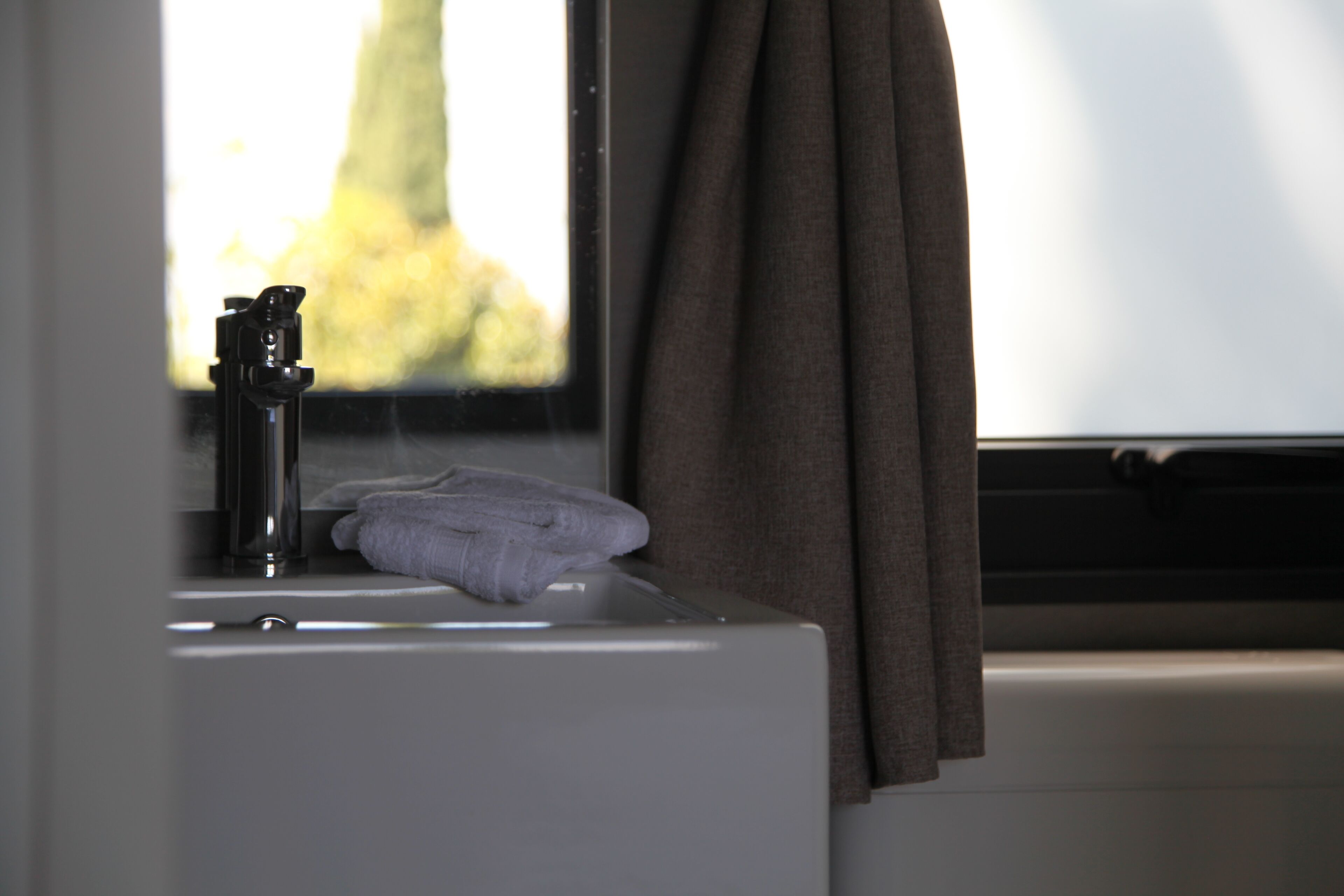 A bathroom sink with a towel and a faucet.