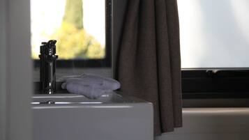A bathroom sink with a towel and a faucet.