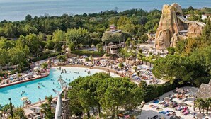 A resort with a large pool, a water slide, and a beach area. - Camping Europa Silvella (Manerba del Garda)