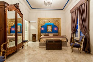 A luxurious bedroom with a large bed, ornate furniture, and a decorative headboard. - Dar Ennassim (La Marsa)