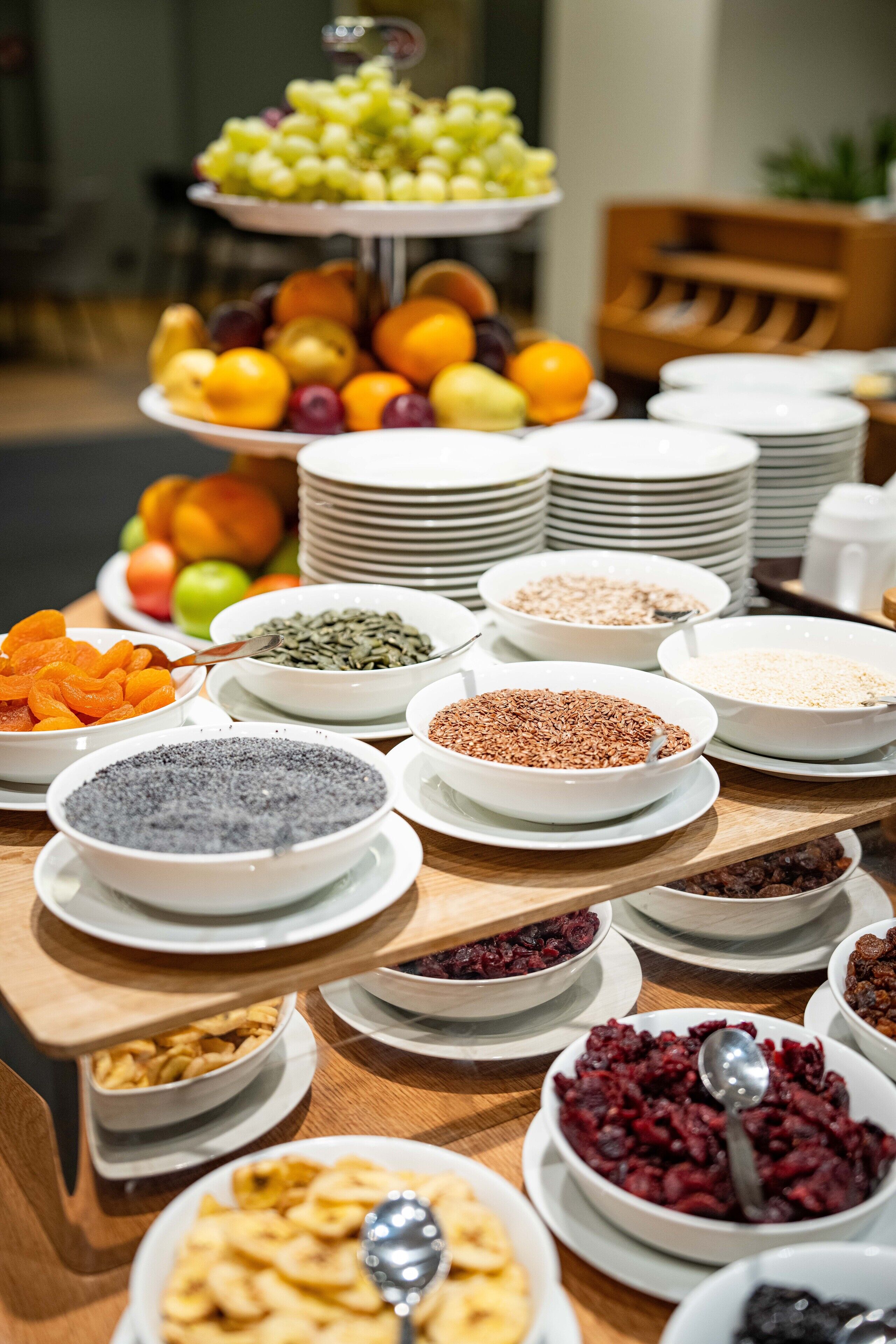 A buffet table with various food items and dishes.