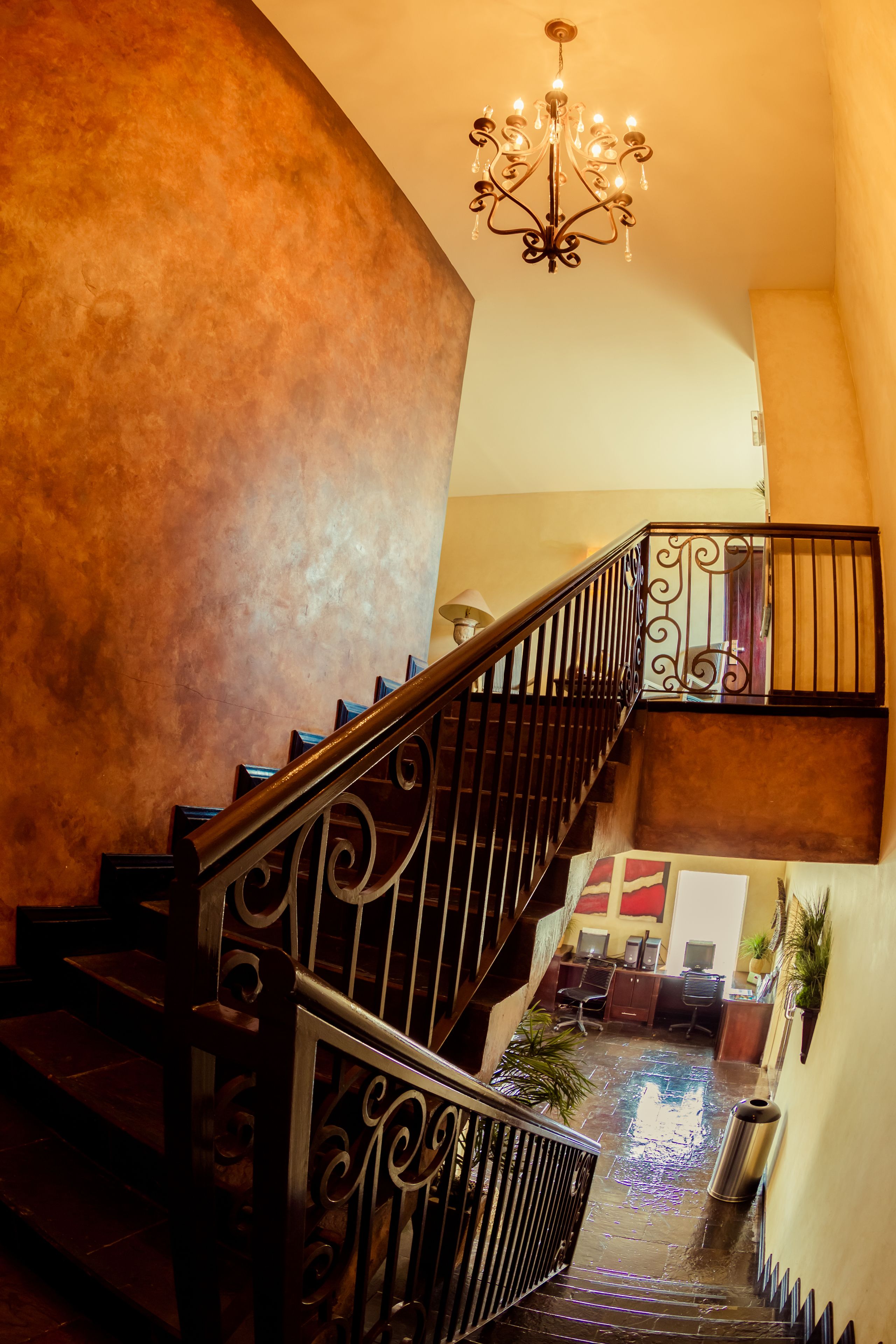 A staircase with ornate metal railings leading to an upper level.