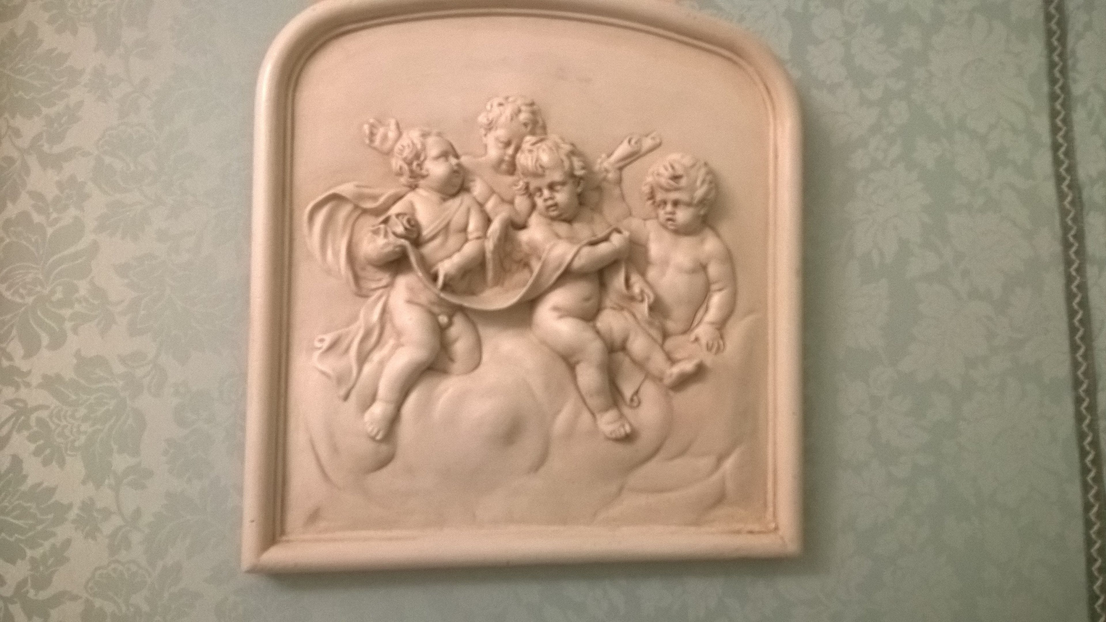 A relief sculpture of cherubs on a wall.