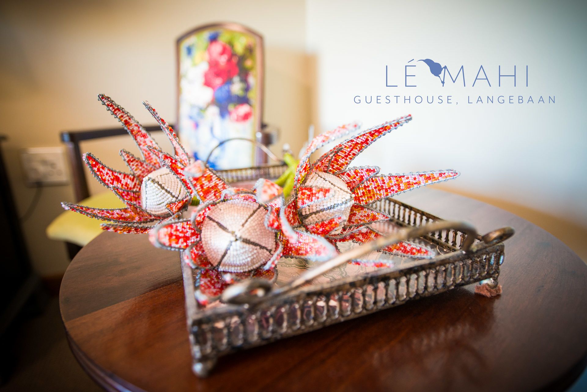 A decorative tray with a lobster centerpiece on a wooden table.