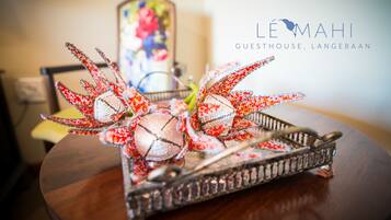 A decorative tray with a lobster centerpiece on a wooden table.
